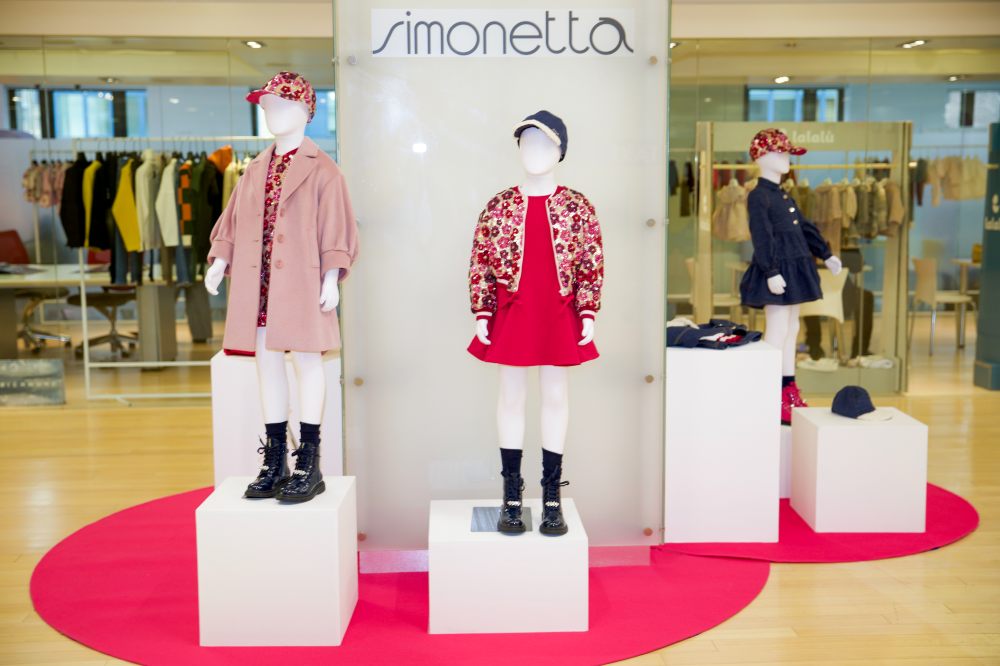 Children's clothes displayed on mannequins on a stand at Children's Show 