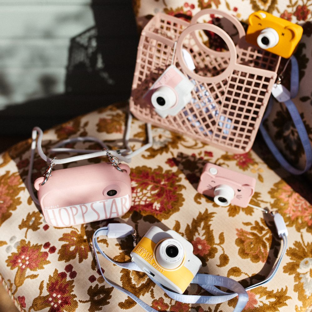 Children's cameras displayed on a retro patterned chair 