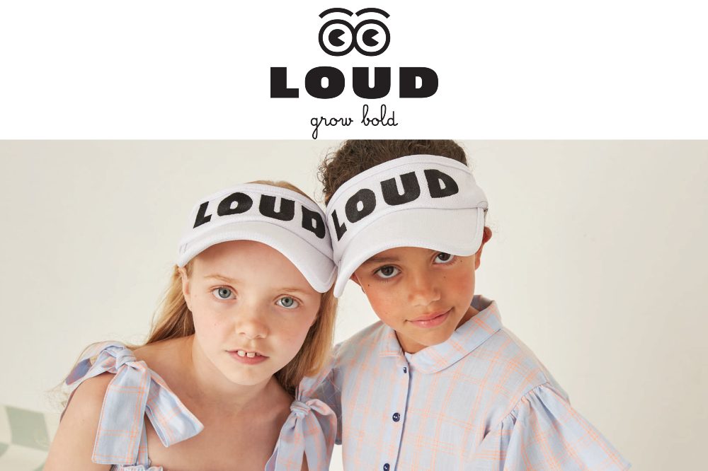 An image of a girl and boy looking at the camera wearing Sun visors with LOUD on the front of them and the LOUD kidswear logo at the top of the image