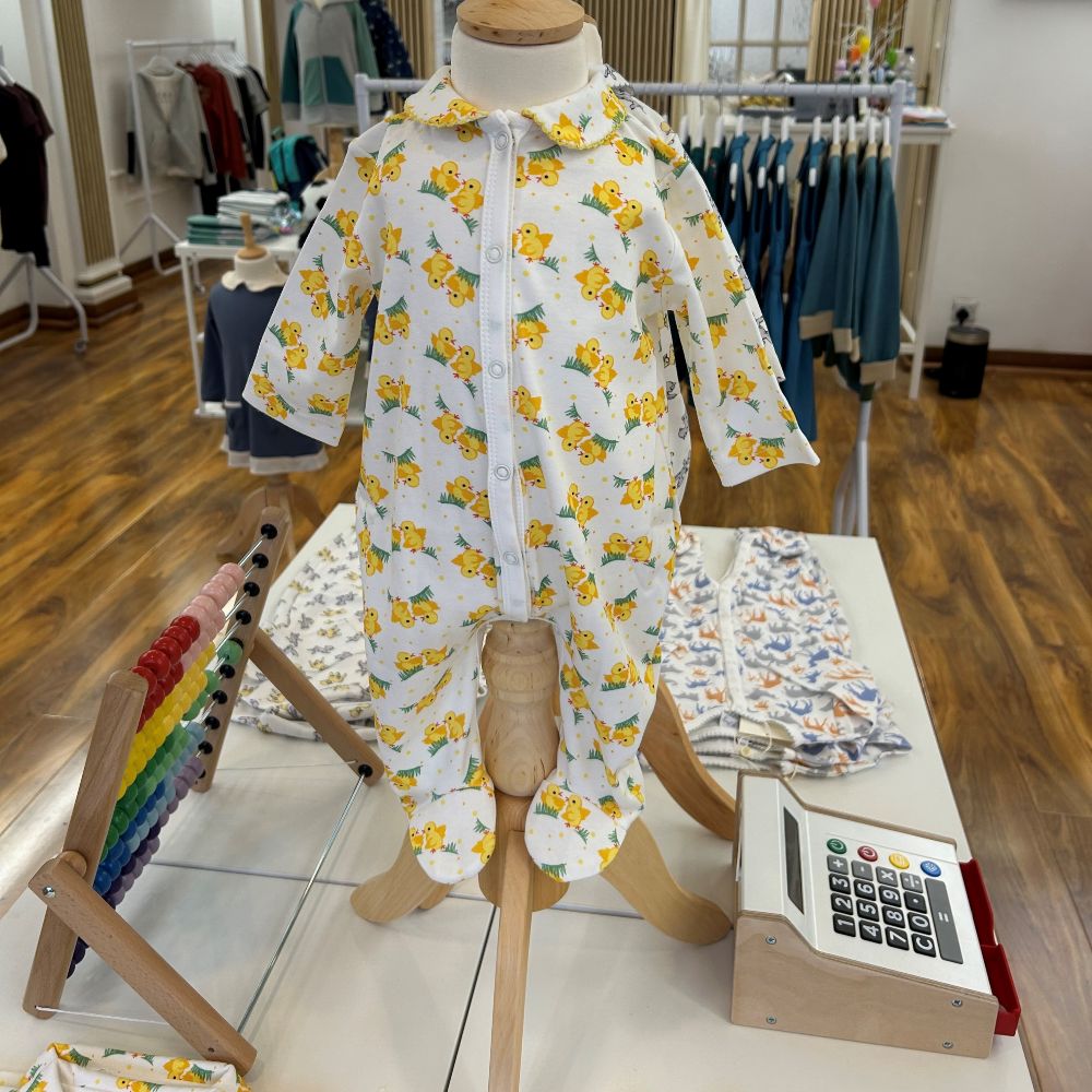 A display with a babygro on a mannequin in a childrenswear shop 