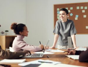 A group of people talking in a boardroom to represent someone selling their business