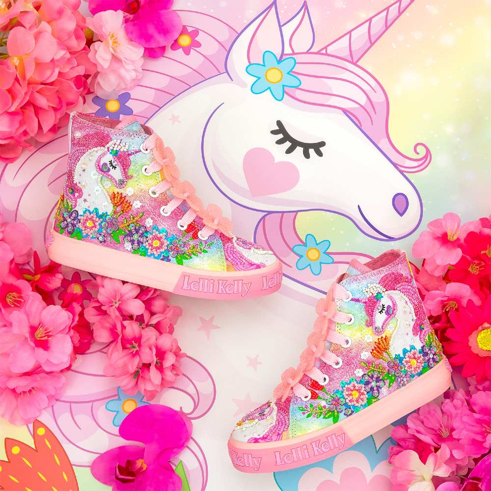 A pair of sparkly children's hi-top trainers with a unicorn design displayed on a unicorn image 