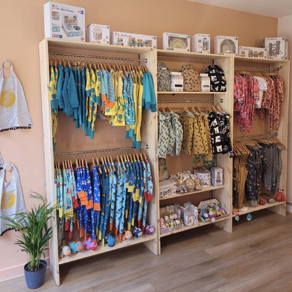 Children's clothes and accessories displayed on shelving in the Little Dots children's shop 