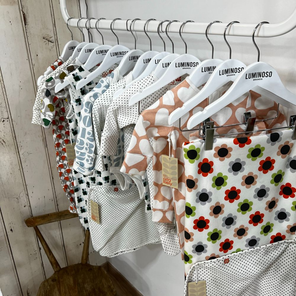 Baby clothes hung on a rail 
