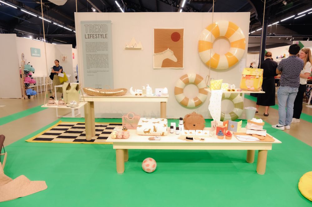 A stand displaying children's clothes and products at the Playtime trade show