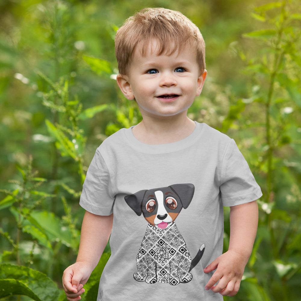 A young boy stood outside in long grass wearing a grey Zuma the Dog T-shirt 