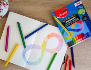 A box of Maped Helix Infinity Colouring Pencils beside a colouring book with an infinity symbol drawn on it