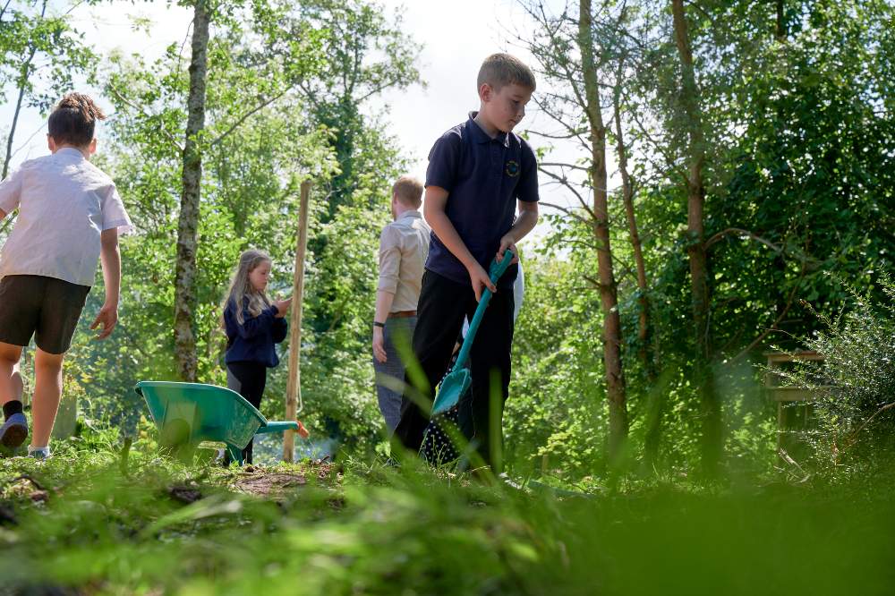 School children gardening in a Nature School