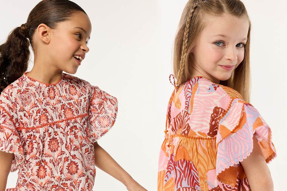 Two girls wearing brightly patterned tops 