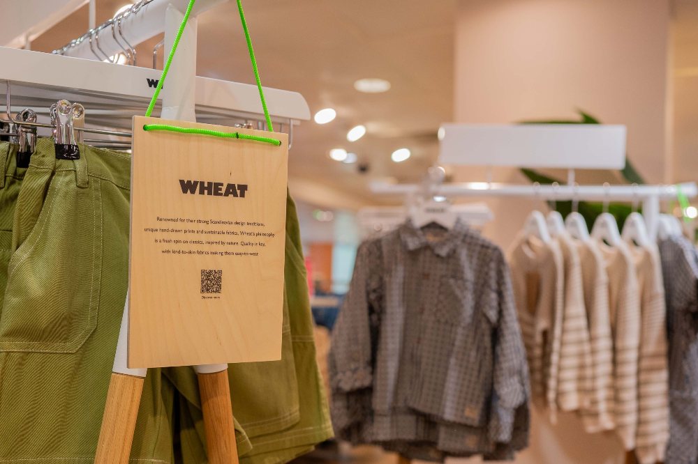 Children's clothes displayed on rails with a Wheat label 