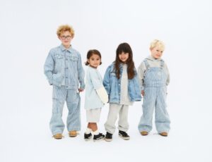 Four children stood in a row wearing denim outfits from the Wheat x Pernille Teisbæk collection