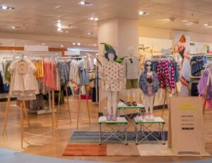 Children's clothes displayed on mannequins and rails in a John Lewis store