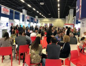 People sat in the UK Pavilion within the Kind + Jugend trade show