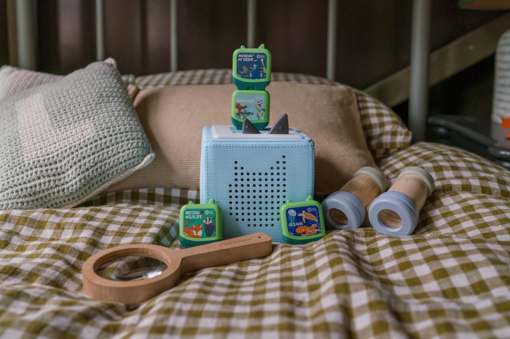 The National History Museum: Discovery Crew 4-piece set as part of tonies® new Clever Pocket Tonie range displayed on a bed in a child's bedroom