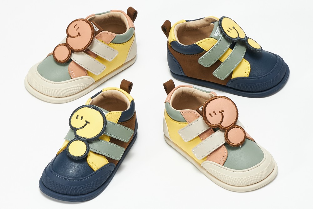 Four children's shoes with a question mark style detail on the tops 