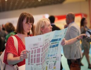 Two woman looking at a floor plan in a hall at IFCO Istanbul Fashion Connection