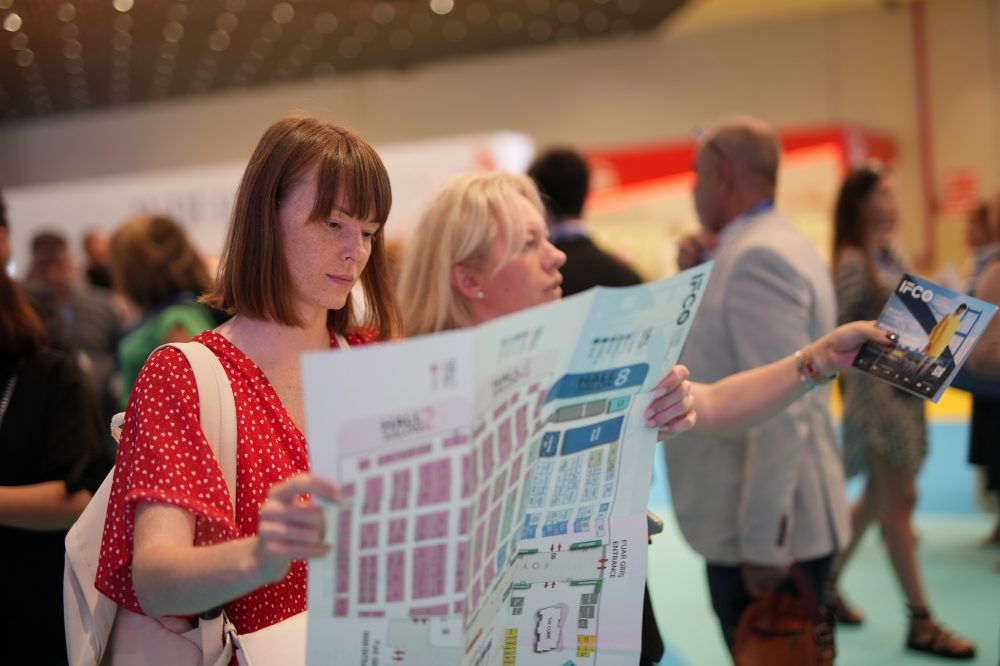 Two woman looking at a floor plan in a hall at IFCO Istanbul Fashion Connection