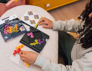 A child sat down playing with a puzzle game