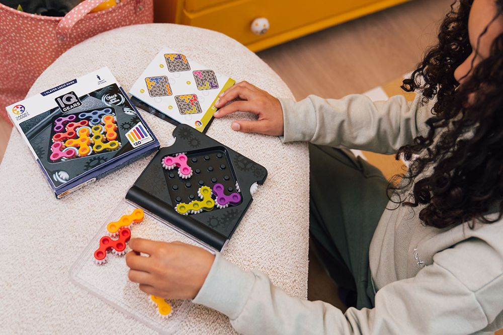 A child sat down playing with a puzzle game