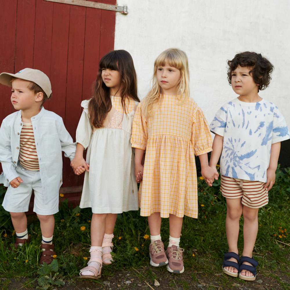 Four children stood outside a building 