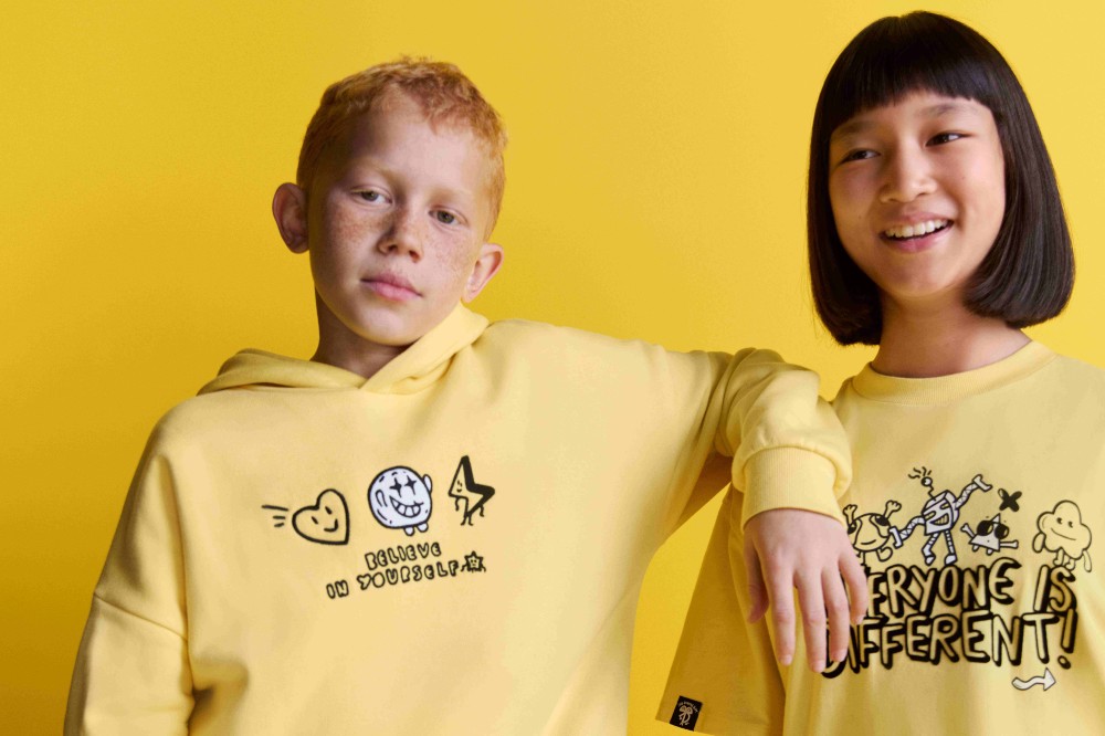 Two children wearing yellow tops