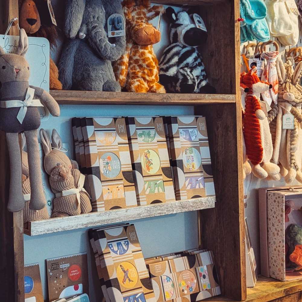 Children's toys and teddies displayed on shelves in a children's shop