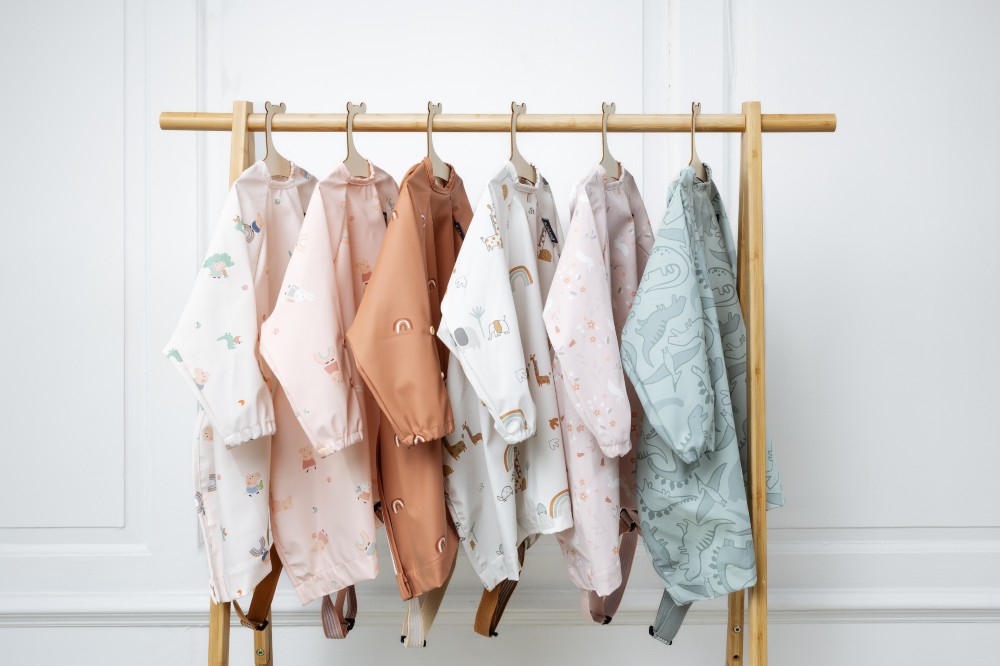 A rail of babies' overall bibs