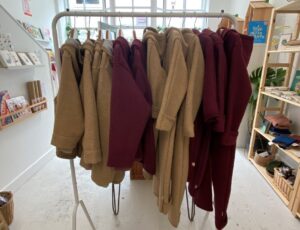 A rail of children's coats inside a children's shop