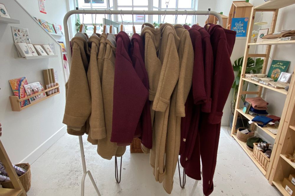 A rail of children's coats inside a children's shop