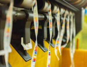 Woven labels being made on a machine by National Weaving