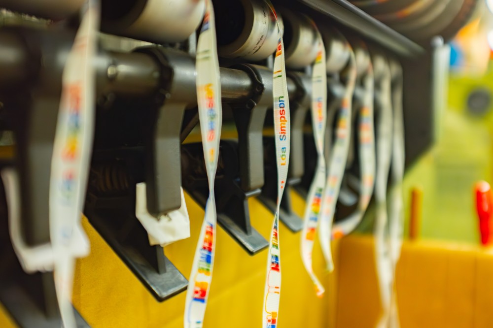 Woven labels being made on a machine by National Weaving