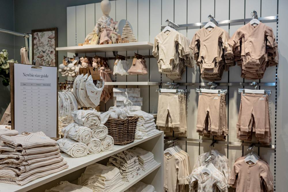 Baby clothes and accessories displayed inside a Newbie UK store