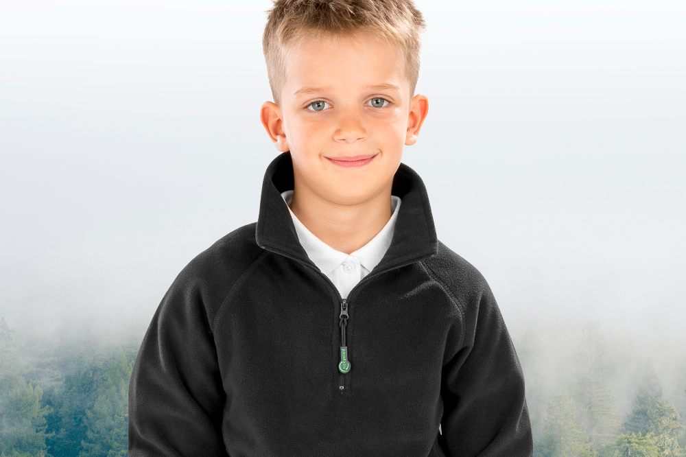 A boy in a black school fleece from the RESULT® Genuine Recycled range