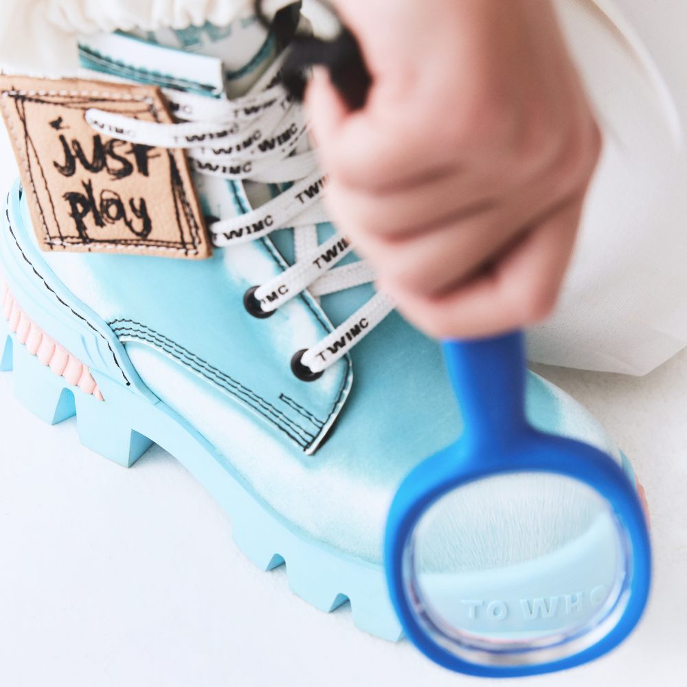 A close-up of a child's blue boot with a magnifying glass 