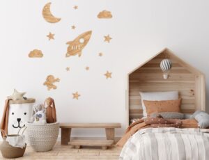 A children's bedroom with space decals on the wall