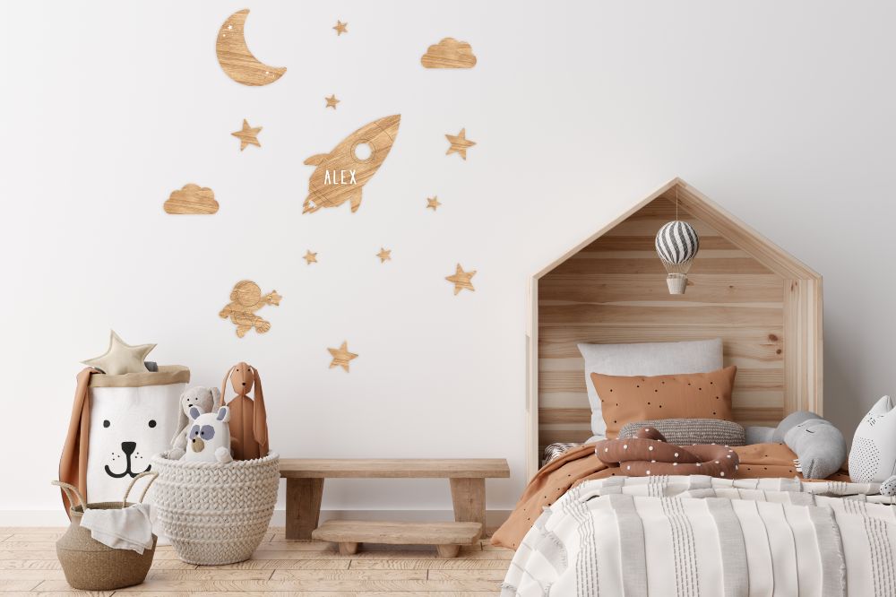 A children's bedroom with space decals on the wall