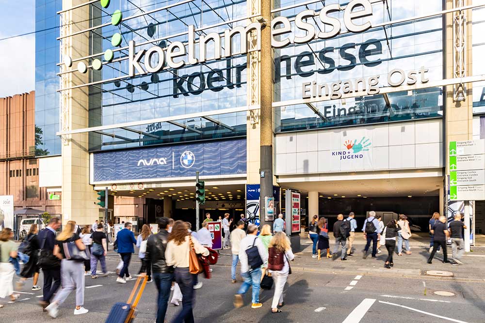 Visitors outside the entrance to Kind + Jugend trade fair