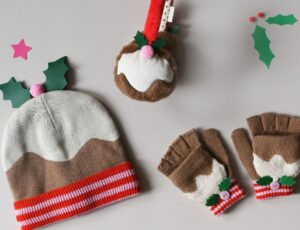 A child's Christmas pudding hat, fingerless gloves and earmuffs by Rockahula Kids