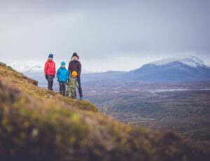 Three children and an adult stood on a mountain to promote Isbjorn Adventure