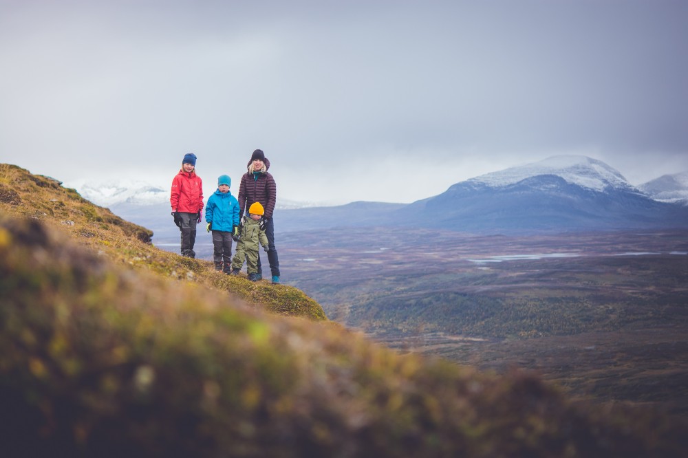 Three children and an adult stood on a mountain to promote Isbjorn Adventure