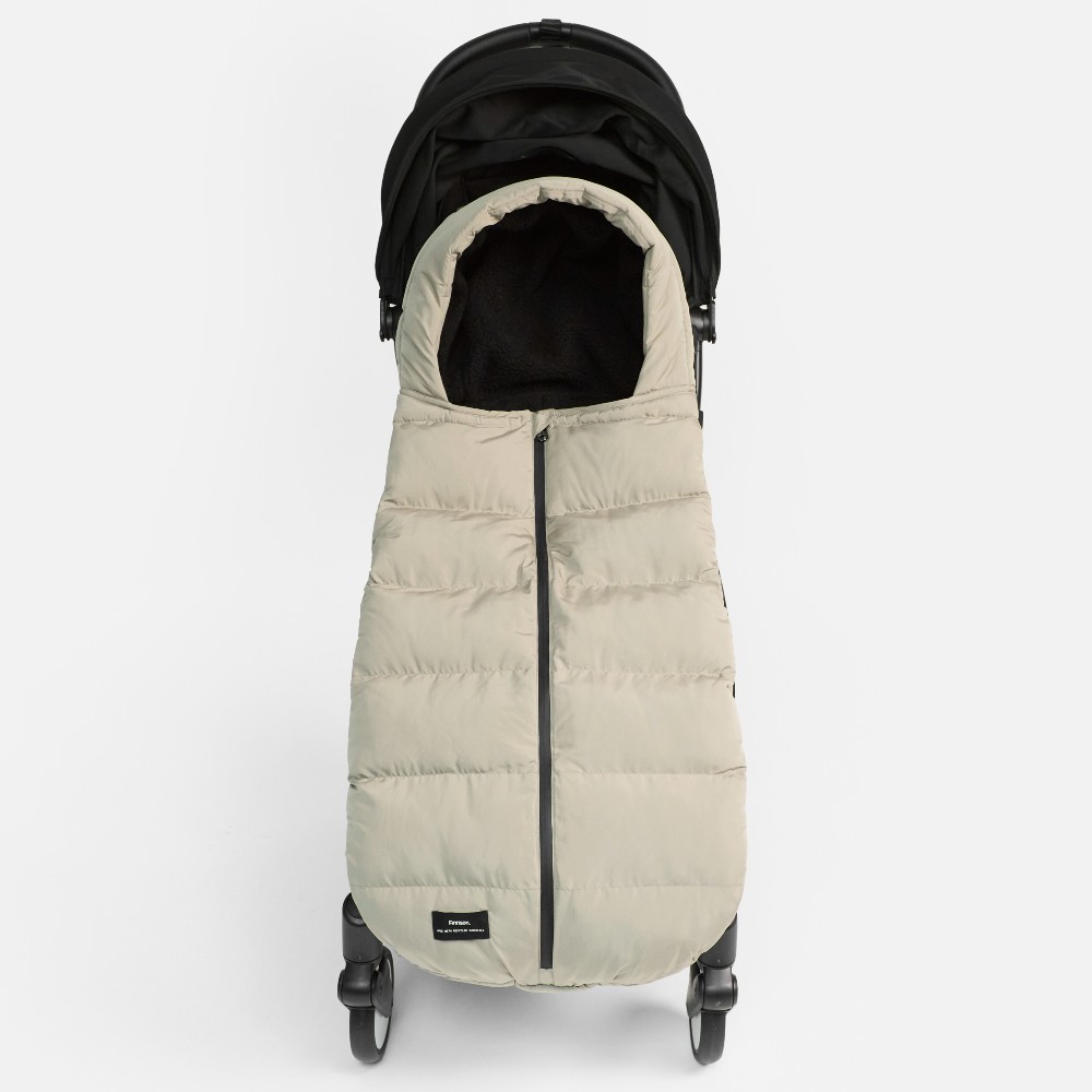 A taupe coloured footmuff displayed in a baby's pushchair 