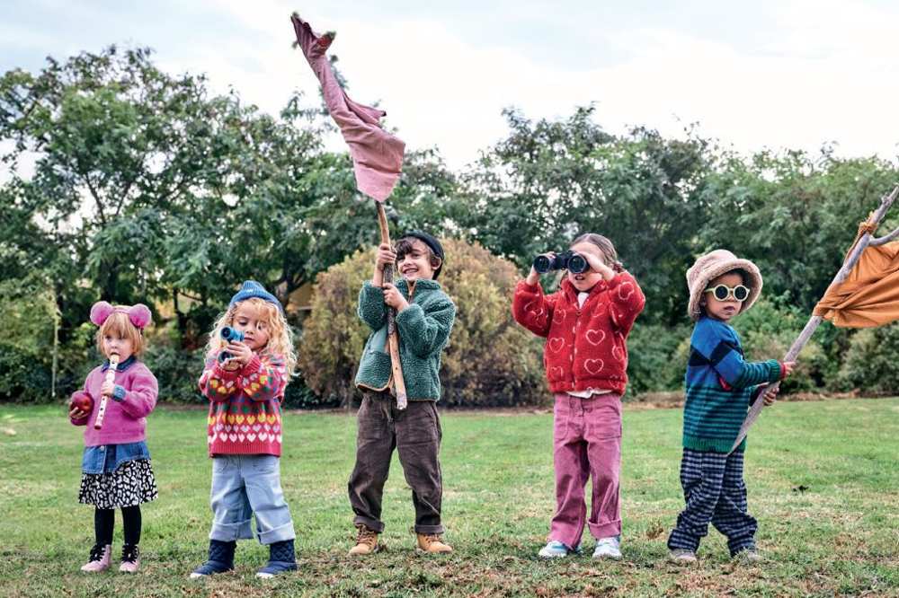 A group of children stood outside in a garden