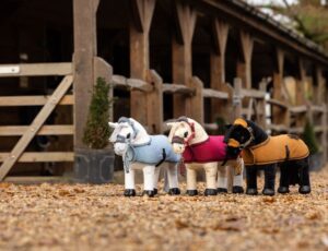 Toy horses by LeMieux displayed outside some stables