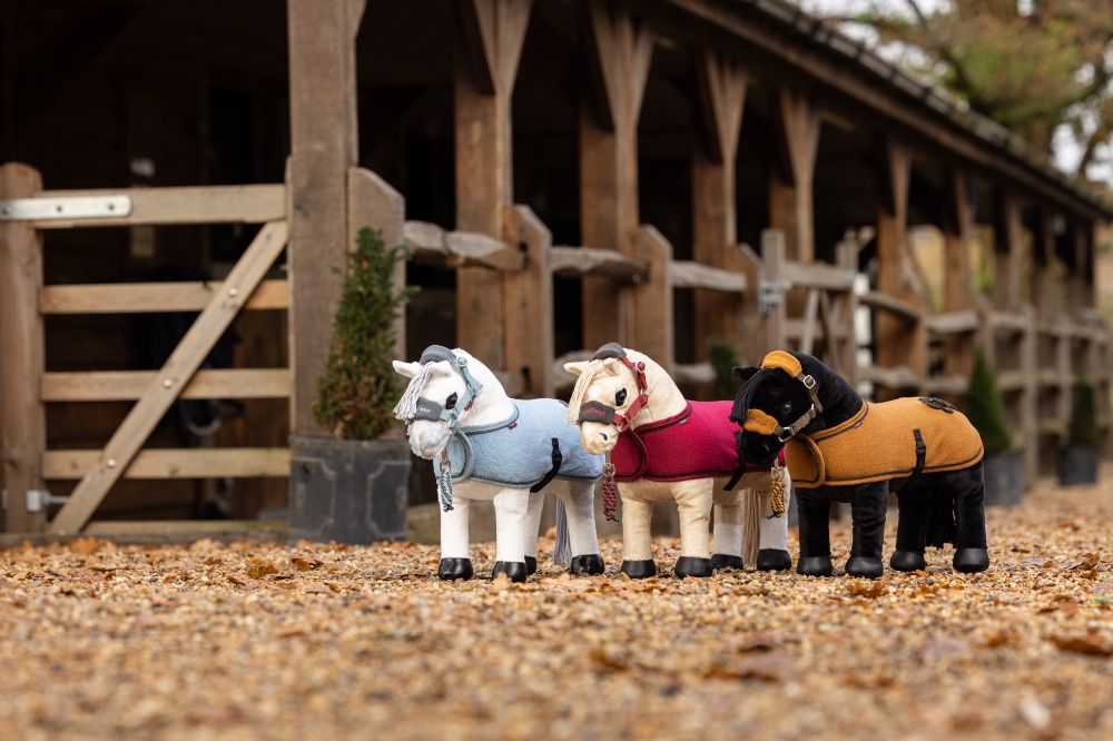 Toy horses by LeMieux displayed outside some stables