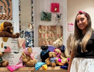 A woman stood beside a display of soft toys from the Loved Before x Free People collaboration