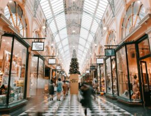 People walking through a shopping mall decorated for Christmas