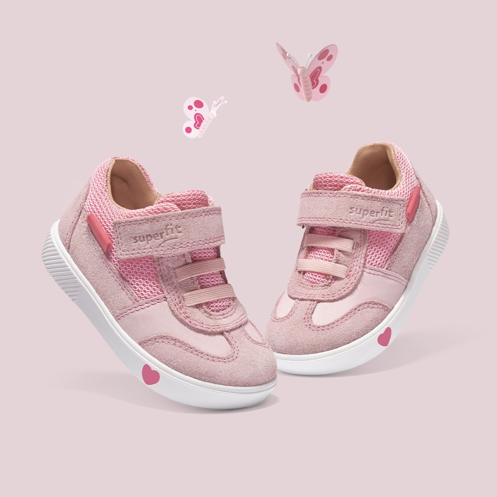 A pair of children's pink trainers with pink butterflies above them