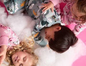 Two girls and a boy playing together on a the floor wearing outfits from PO.P's new Moomin collection