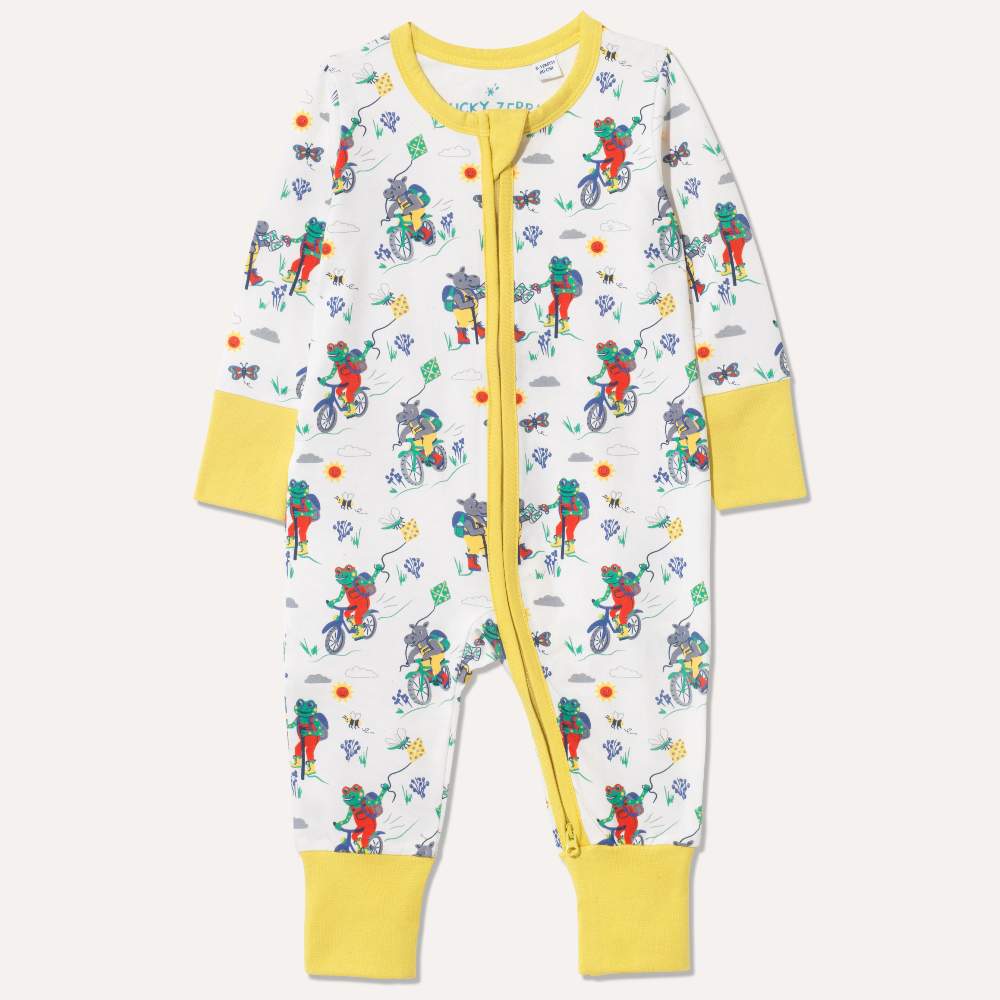 A child's babygro with a frog and hippo print 