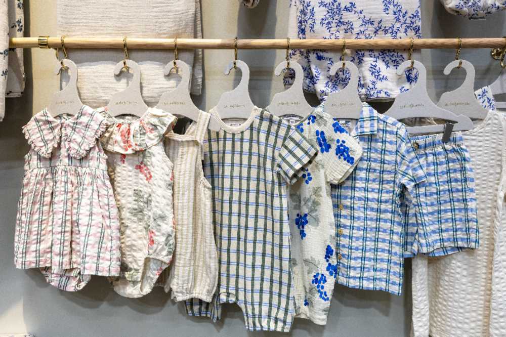 baby clothes displayed on a rail at Kind + Jugend